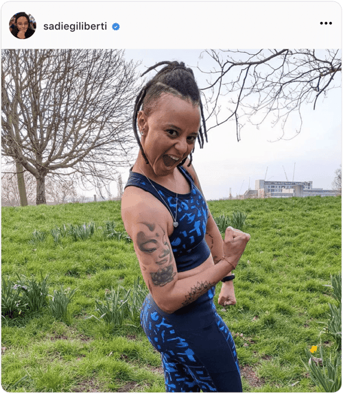 Influencer Sadie Giliberti in a park showing off her biceps