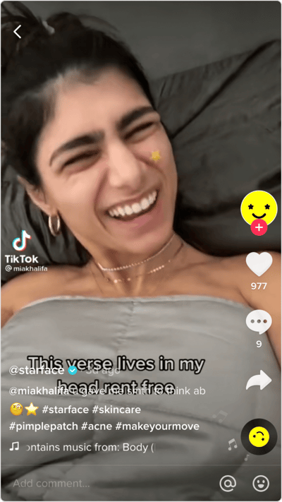 Screenshot of TikTok with woman smiling with a star on her face