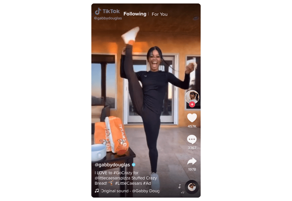 TikTok screenshot, woman holds her right leg high and smiles