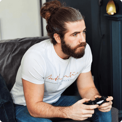 Man with a beard plays video games intently