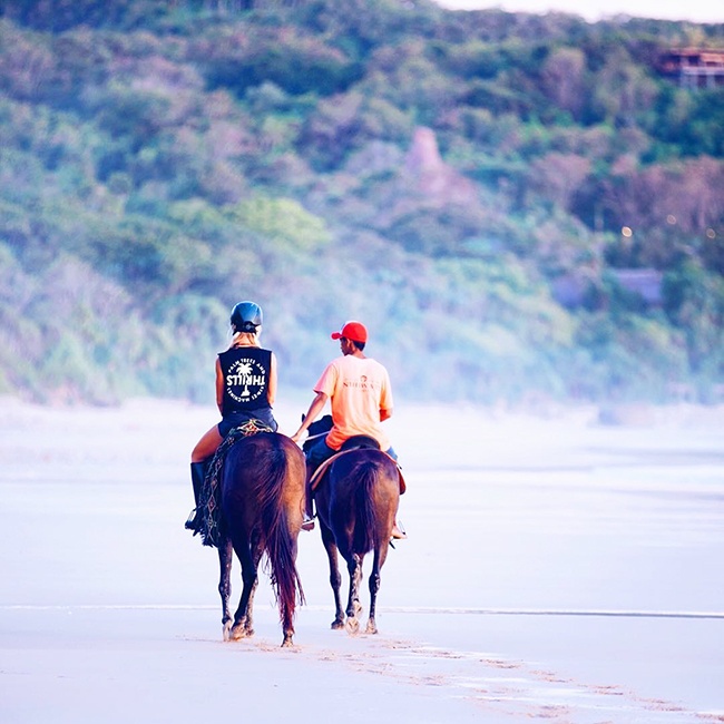 Rebecca-gawthorne-riding-a-horse-on-a-beach