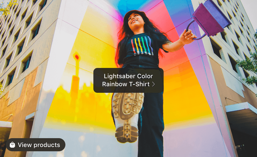 Low angle photo of person wearing a black tshirt in front of a ranbow wall