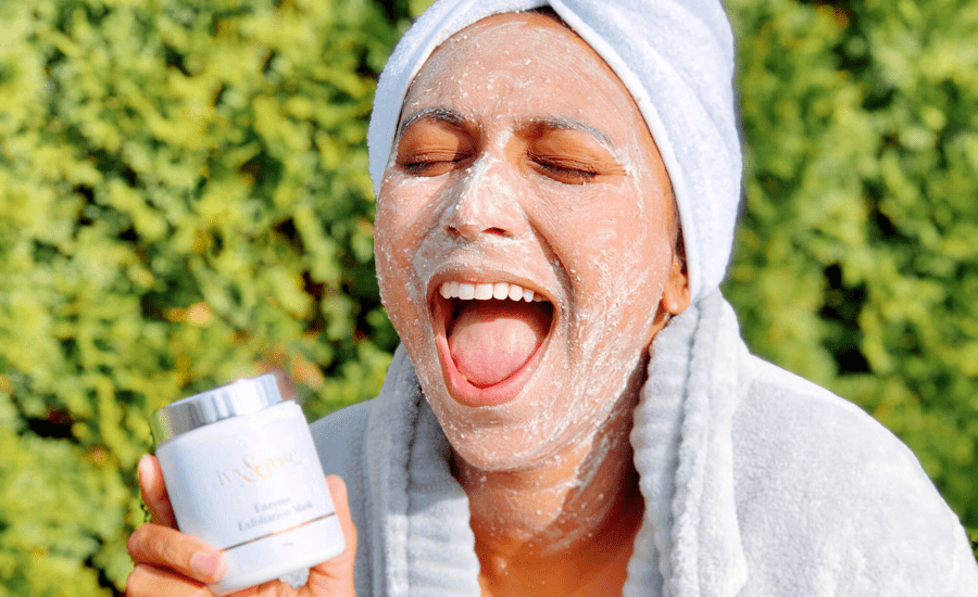 Woman with face cream on smiling with her eyes closed