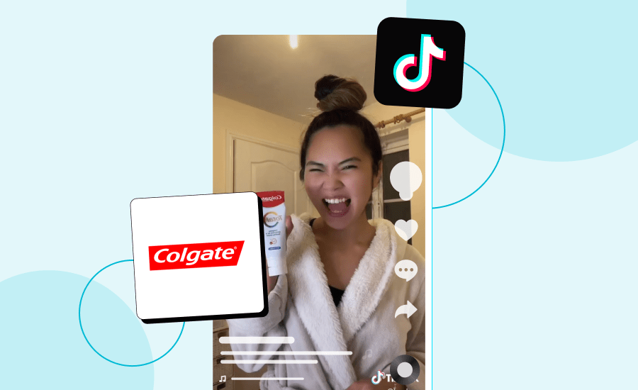 Screenshot of a TikTok featured an excited woman with a top bun showing off her toothpaste