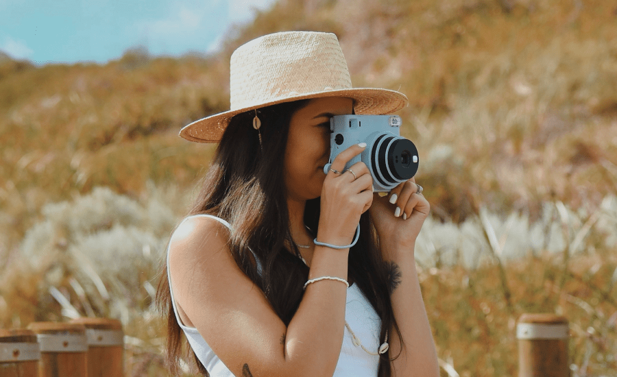 Woman take a photo with a blue camera