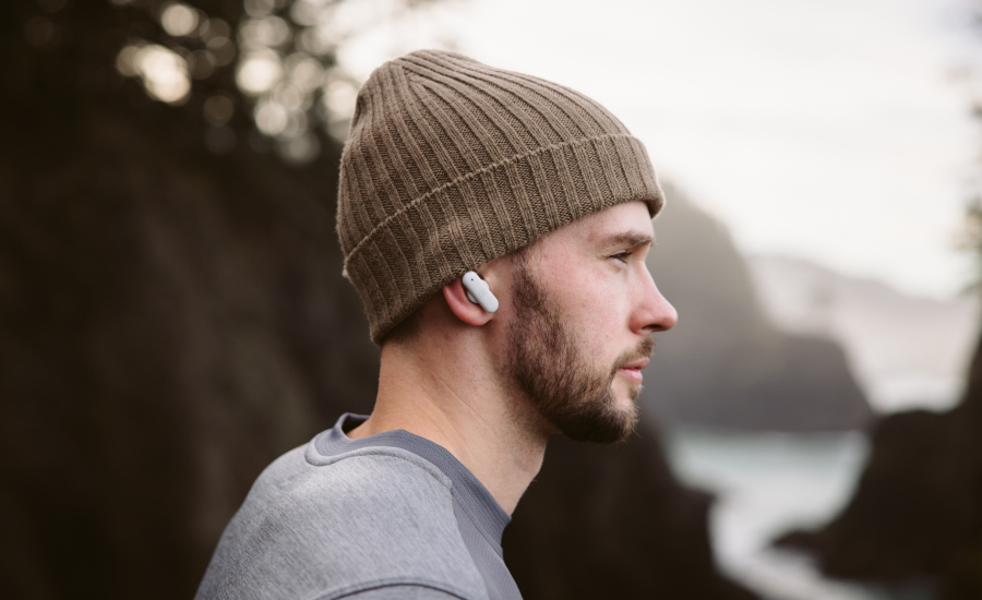 Tyler Glass for Ultimate Ears - a young bearded man looks into the distance while wearing ear phones