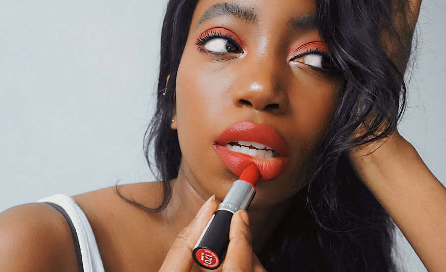 TRIBE creator @tatikapaya applying red lipstick in content shot for Rimmel London